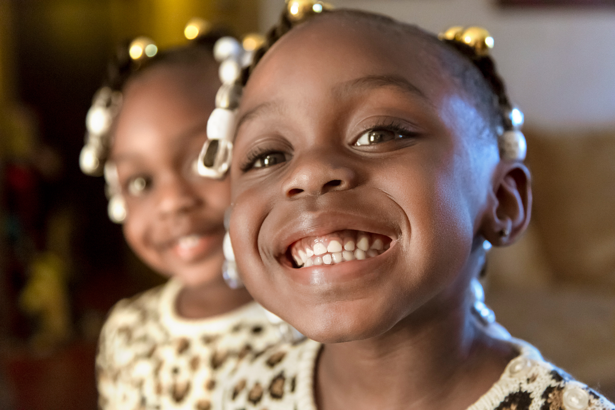 Little girls smiling at the camera.