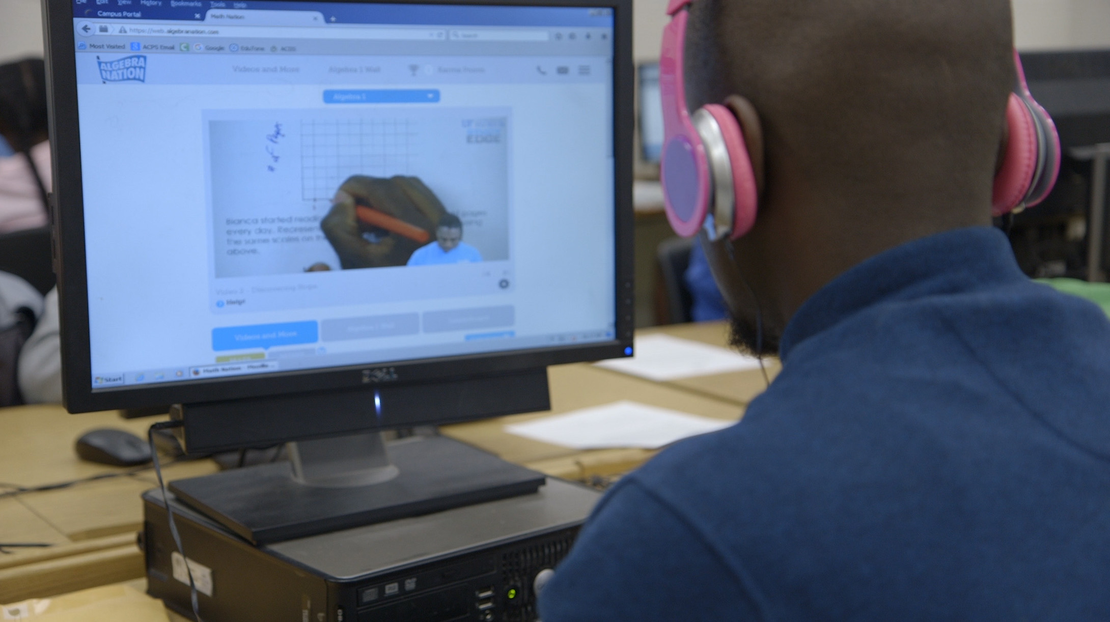 A student looking at a computer screen with Math Nation