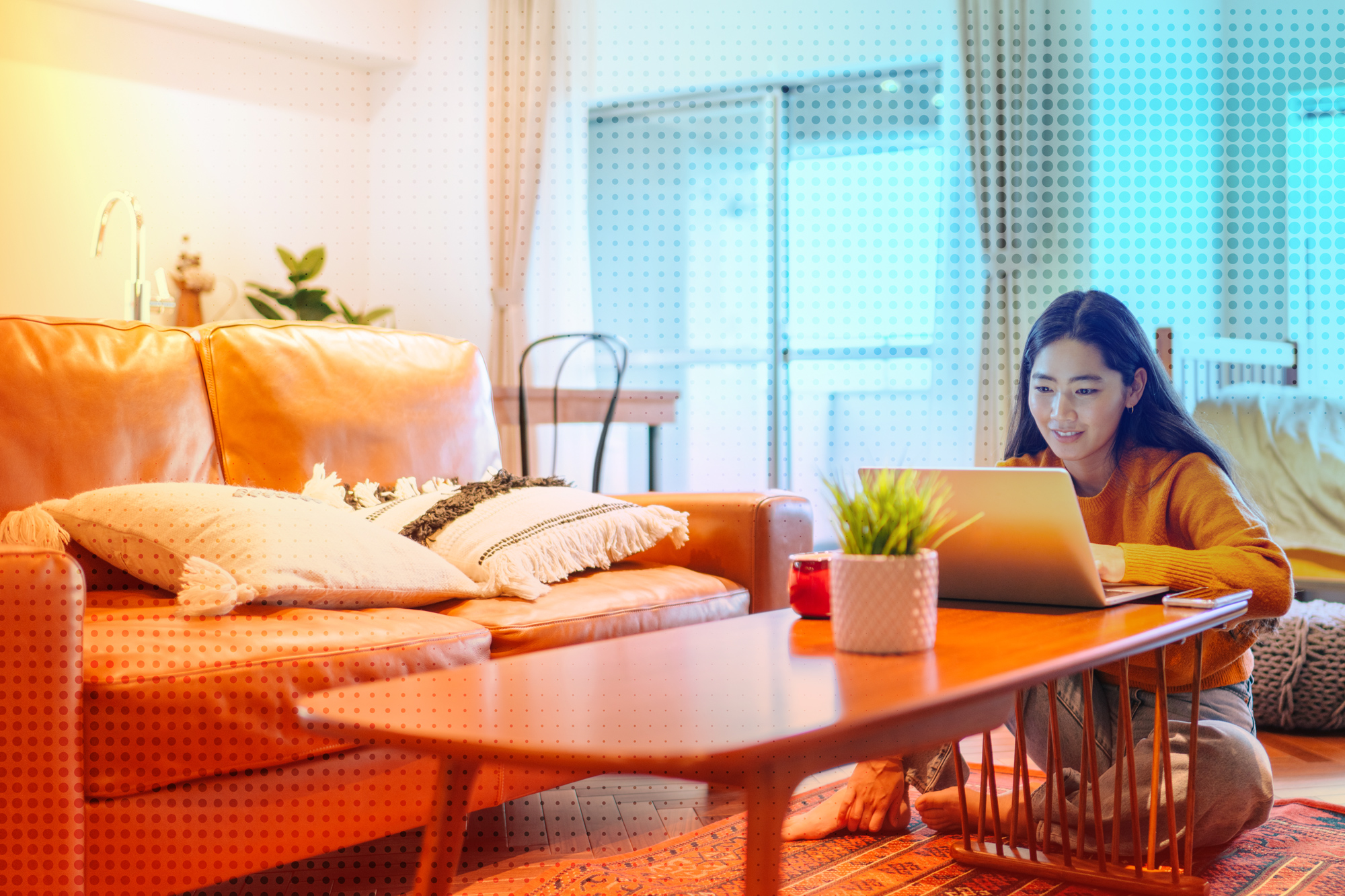 Woman sitting at a coffee table using a laptop - orange and blue gradient filter overlay